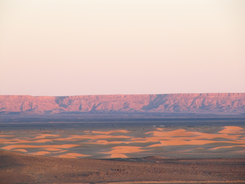 near Merzouga - Saharan sunset - Erg Chebbi dunes in foreground - the ridge is the Algerian border