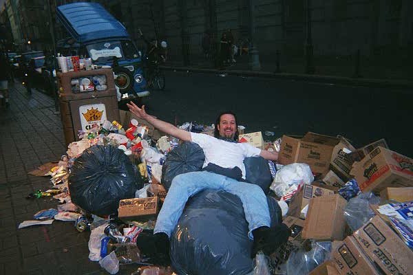 Chad flings himself into one of the many trash piles. Note the Mystery Machine in the background